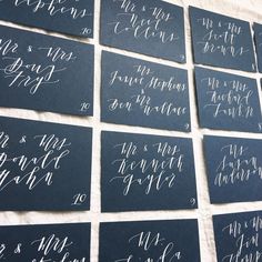 many different types of calligraphy written on black paper with white ink are arranged in rows