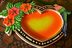 a heart shaped cake decorated with flowers and birds