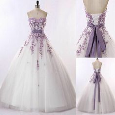 a white and purple wedding dress with flowers on it