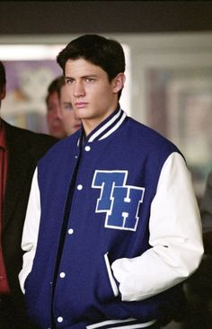 a young man in a blue and white jacket