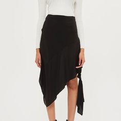 Try A Contemporary Shape With This Silk Midi Skirt Featuring A Knot Side Tie Detail. Made In Britain By Boutique. Pair With A Blouse Or A Cropped Ribbed Jumper. 100% Silk Machine Wash Color: Black Small Pin Hole Where Tag Was Attached Black Asymmetrical Hem Wrap Skirt For Party, Black Wrap Skirt With Asymmetrical Hem For Party, Black Draped Skirt With Asymmetrical Hem For Spring, Black Asymmetrical Draped Skirt For Spring, Black Draped Skirt With Asymmetrical Hem For Summer, Black Asymmetrical Draped Skirt For Summer, Chic Black Asymmetrical Wrap Skirt, Elegant Black Ruffled Draped Skirt, Black Asymmetrical Hem Mini Skirt For Work