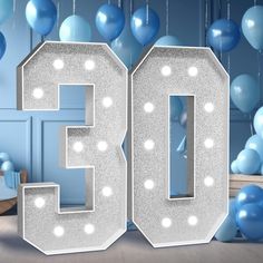 the number 50 is surrounded by balloons and streamers in front of a blue wall