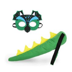 a green and yellow dragon costume with a black mask on it's face next to a green alligator tail