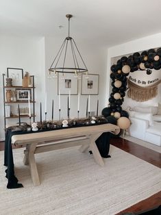 a table with candles and decorations on it in a living room next to a couch