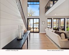 a living room filled with furniture and windows