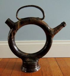 a metal object sitting on top of a wooden floor