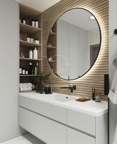 a bathroom with a large round mirror above the sink and shelves on the wall behind it