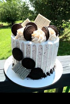 a cake with oreo cookies and cream frosting on top sitting on a table