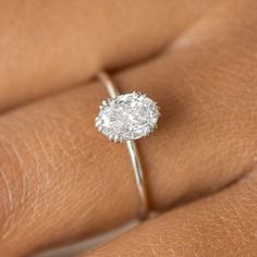 a woman's hand with a diamond ring on it