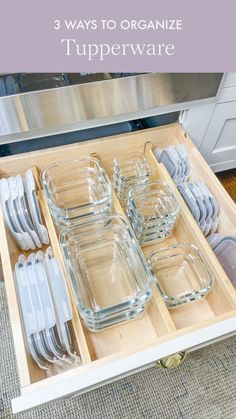 an open drawer filled with glass dishes and utensils