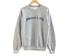 Brooklyn New York Unisex Pullover Crewneck. The perfect vintage sweatshirt for your favorite city. - Unisex Size - Printed on the Gilden 1800 Sweatshirt - Loose fit - 50% Cotton; 50% Polyester (fibre content may vary for different colors) - Processing usually takes 3-5 and shipping usually takes 3-5 days - Medium fabric (8.0 oz/yd² (271.25 g/m - Sewn in label - Runs true to size *Personal customization is available. Please don't hesitate to reach out to us to inquire about personalized designs. Ohio Sweatshirt, Michigan Sweatshirt, Sweat Vintage, Staten Island New York, California Sweatshirt, New York Sweatshirt, Breckenridge Colorado, Mesa Arizona, Vintage Crewneck