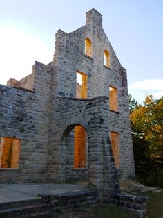 an old stone building with windows and steps