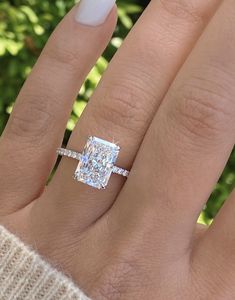 a woman's hand with a diamond ring on it