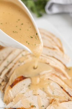 a white plate topped with meat covered in gravy