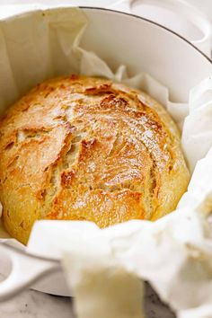 a loaf of bread in a white bowl