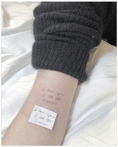 a person's arm with a note attached to it that says, i love you