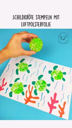 someone is making a paper plate with seaweed and turtle silhouettes on the side