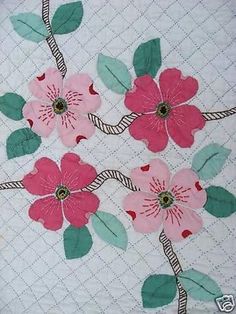 pink flowers on white quilt with green leaves