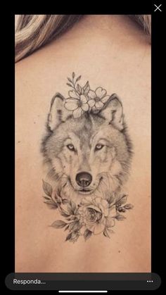 the back of a woman's shoulder with a wolf and flowers on her head