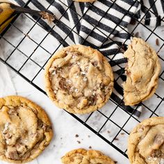 chocolate chip cookies cooling on a wire rack with a banana in the backgroud