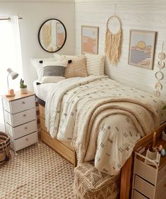 a bed room with a neatly made bed and pictures on the wall