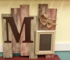 a wooden block with the letter m on it and a small photo frame next to it