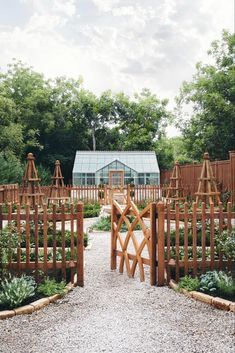 an outdoor garden with wooden fences and plants