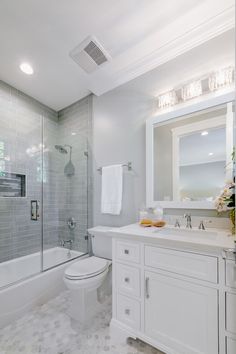 a bathroom with a toilet, sink, and shower in it's own area