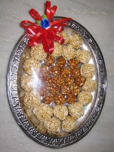 a silver platter filled with lots of food on top of a white countertop