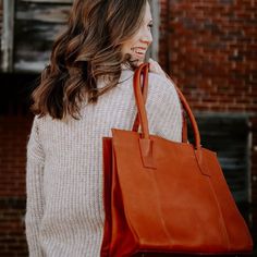 This tote will float your boat! Extra comfortable padded rolled handles and an interior loaded with convenient secure pockets. Details 100% Full-grain leather handcrafted by artisans in South America and India. Every hide is unique so you will notice natural variations in the grain texture and shading which are hallmarks of high-quality. Can accommodate up to 15" laptop Large, single compartment Shoulder Bag w/ top snap closure Fully lined interior with organizer, 2 zip pockets, phone pocket, an Festival Tote Bag, Pockets Details, Float Your Boat, Grain Texture, Design Essentials, Best Brand, High Quality Leather, Full Grain Leather, South America