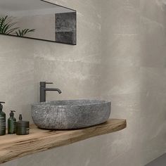 a bathroom sink sitting on top of a wooden counter