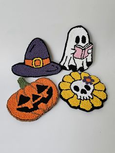 four halloween patches with pumpkins, ghost, and jack - o'- lanterns