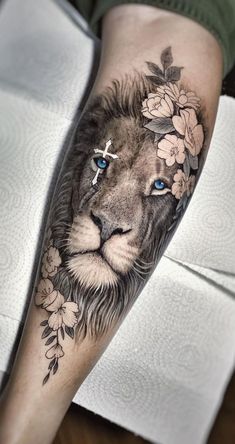 a lion with blue eyes and flowers on his leg