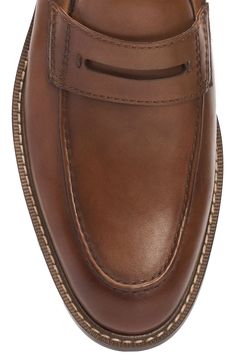 An apron toe and classic penny keeper accentuate the streamlined style of a luxe leather loafer designed with tonal stitching for timeless appeal. Leather upper/synthetic and textile lining/rubber sole Imported Classic Cognac Moc Toe Loafers, Classic Cognac Moccasins With Round Toe, Timeless Brown Moc Toe Moccasins, Masculine Workwear Moccasins With Brogue Detailing, Penny Loafers Men, An Apron, Penny Loafer, Penny Loafers, Leather Loafers