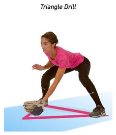 a woman in pink shirt and black leggings doing stretching exercises on blue mat