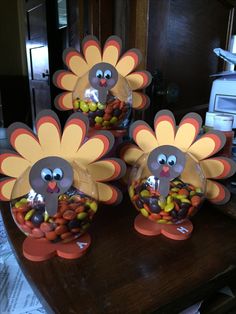 three turkeys with candy in them on a table