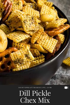 a bowl filled with chex mix next to corn chips and pretzels on the side