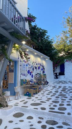 an alley way with polka dot tiles on the floor and tables in front of it