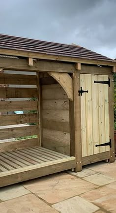 a wooden storage shed sitting on top of a patio