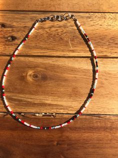 A beautiful hand made seed bead choker, 15 inches long. Gift Heishi Beaded Necklaces With Black Beads, Adjustable Beaded Choker, Festival Heishi Beads Choker Necklace, Handmade Red Heishi Beads, Festival Polished Bead Choker Necklace, Festival Choker With Polished Round Beads, Beach Red Beaded Choker, Bohemian Heishi Bead Choker Necklace, Handmade Bohemian Heishi Beads Choker