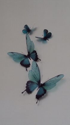 three blue butterflies flying in the air