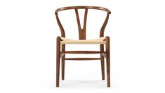 a wooden chair with a beige seat and back rest on a white background the chair has a woven seat pad in front of it