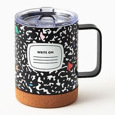 a black and white coffee mug with writing on the front, surrounded by confetti sprinkles