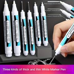 a person holding a pen in front of six different sized toothbrushes with instructions on how to use them