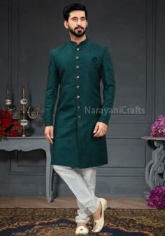 Product Description - The first and most important rule of men's style is you should feel comfortable and confident in your clothes. You will need both these attributes to pull off just about any outfit successfully. A suit that fits increases your confidence and makes you look good. Regardless of how 'classy' or expensive they might be. New Stylish handmade Decent Sherwani for men for wedding and festive occasions.  Stylish New Ethnic Sherwani for men Top Details  -  Color  - Teel Green Fabric Semi-formal Traditional Wear With Long Sleeves For Festivals, Semi-formal Long Sleeve Traditional Wear For Festivals, Fitted Green Cotton Bandhgala, Cotton Traditional Wear For Semi-formal Occasions, Traditional Green Semi-formal Sets, Semi-formal Cotton Traditional Wear With Long Sleeves, Green Fitted Kurta With Stand Collar, Green Traditional Wear For Groom, Traditional Winter Kurta For Semi-formal Occasions