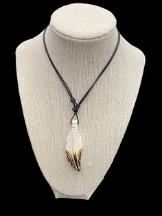 Here is a cool bone carved eagle feather style pendant necklace on an adjustable cord slide rope.  Perfect gift for someone special or addition to your jewelry collection.  This is a one size fits all.  Feather is 2"1/2  Coming from Wyoming Adjustable White Feather Jewelry, Adjustable Feather Necklace As Gift, White Necklace With Adjustable Waxed Cord, Powwow Regalia, Eagle Feather, Feather Pendant Necklace, Taxidermy Art, Eagle Feathers, Feather Pendant