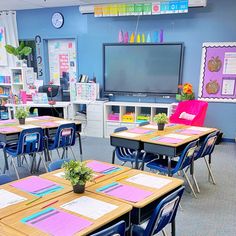 a classroom with desks, chairs and a television on the wall in front of it