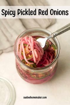 pickled red onions in a mason jar with spoon on the side and text overlay that reads spicy pickled red onions