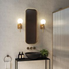 a bathroom with a sink, mirror and lights on the wall next to an open door