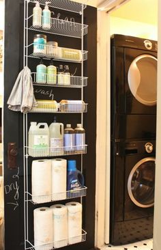 a washer and dryer sitting next to each other in a room with black walls